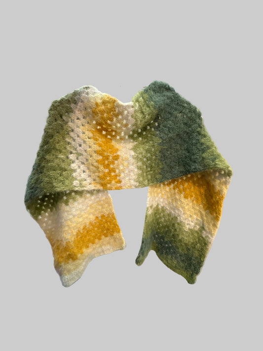 Crocheted shawl/scarf with green and yellow gradient on a gray background