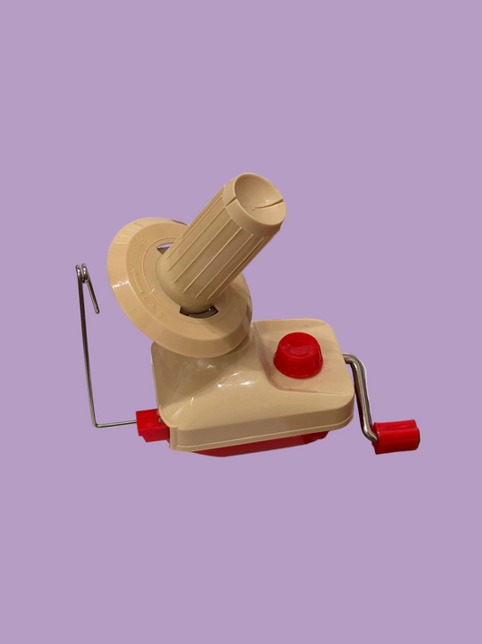 Beige and red mechanical device on a light purple background